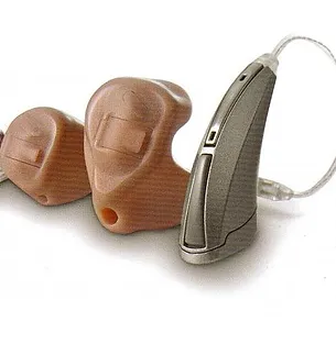 A pair of hearing aids are laying next to each other.