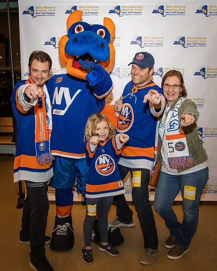 A group of people posing for a picture with the mascot.