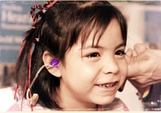 A young girl with ear buds in her ears.